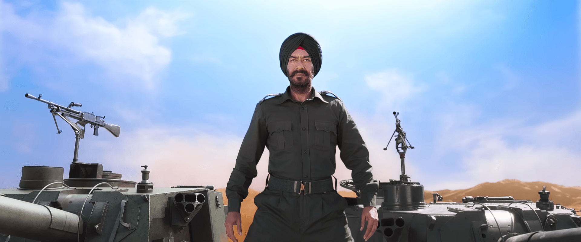 A soldier in a turban stands confidently between two military tanks under a bright sky in a desert setting.